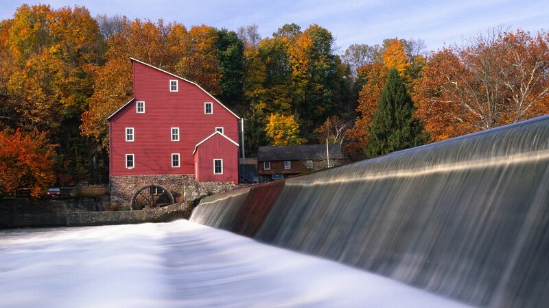 Red mill by a waterfall