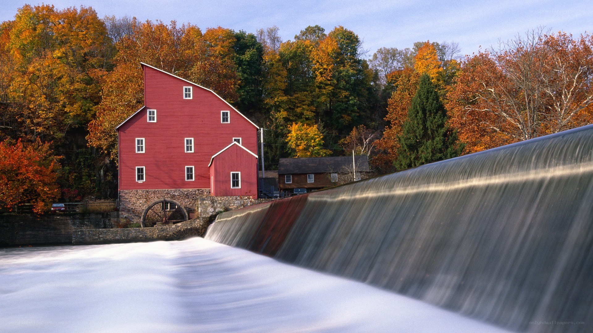 Red mill by a waterfall