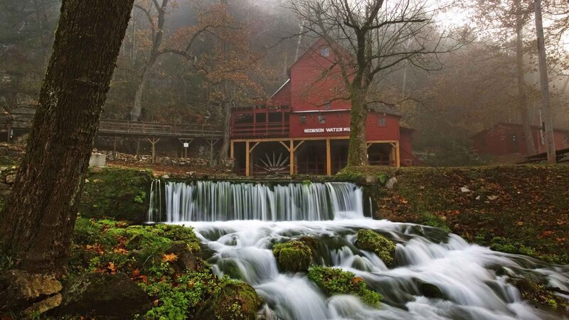 Red mill by a waterfall