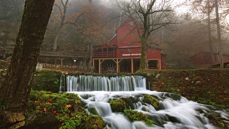 Red mill by a waterfall