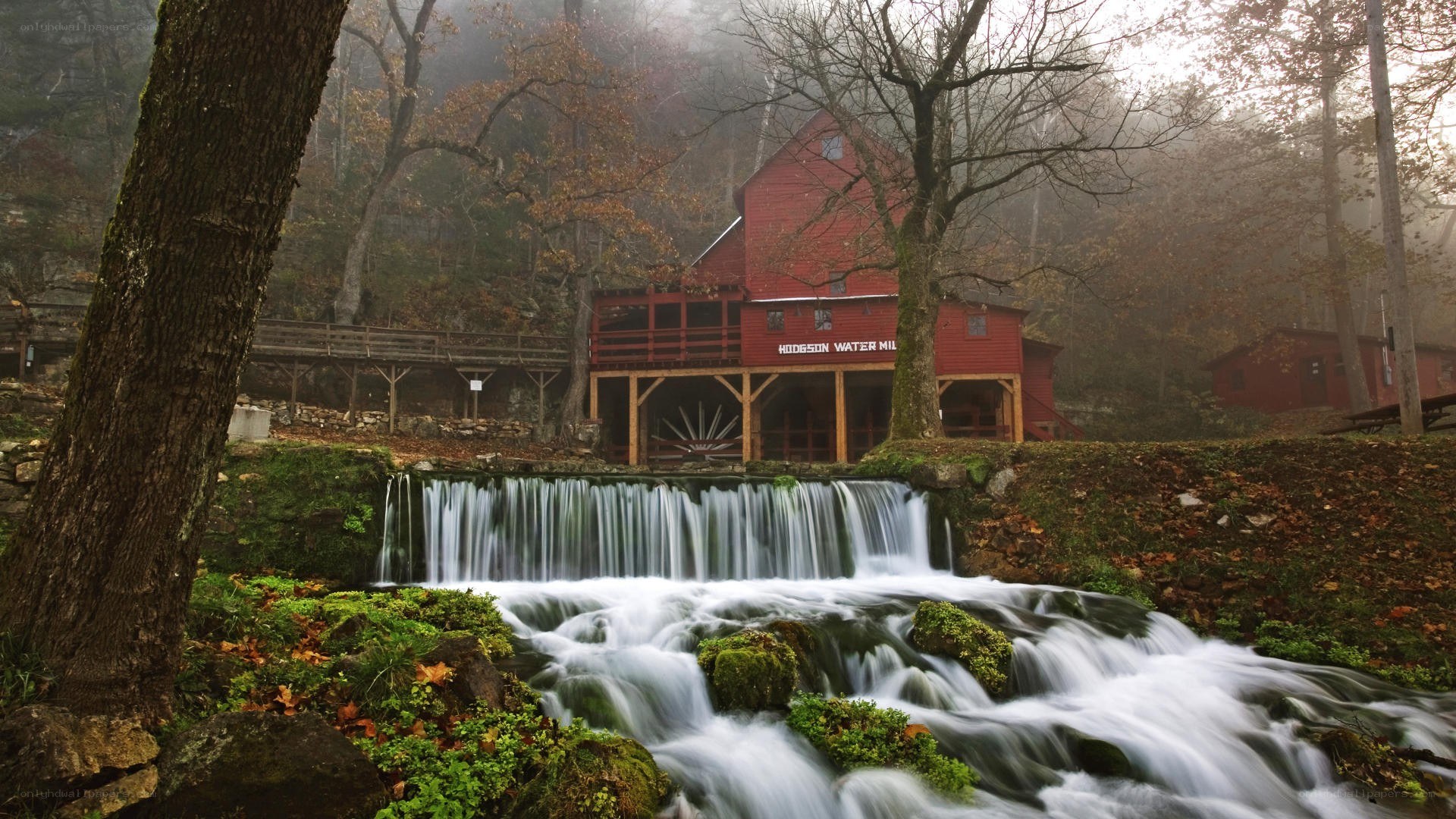 Red mill by a waterfall