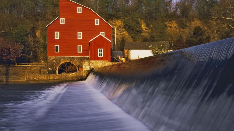 Red mill by a waterfall