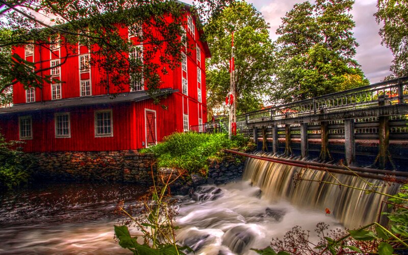 Red mill by a waterfall