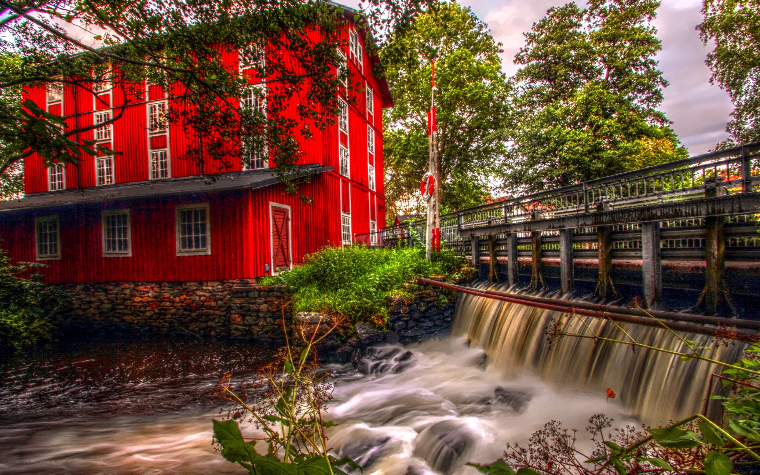 Red mill by a waterfall