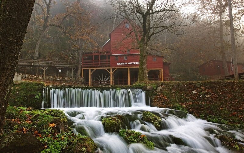 Red mill by a waterfall