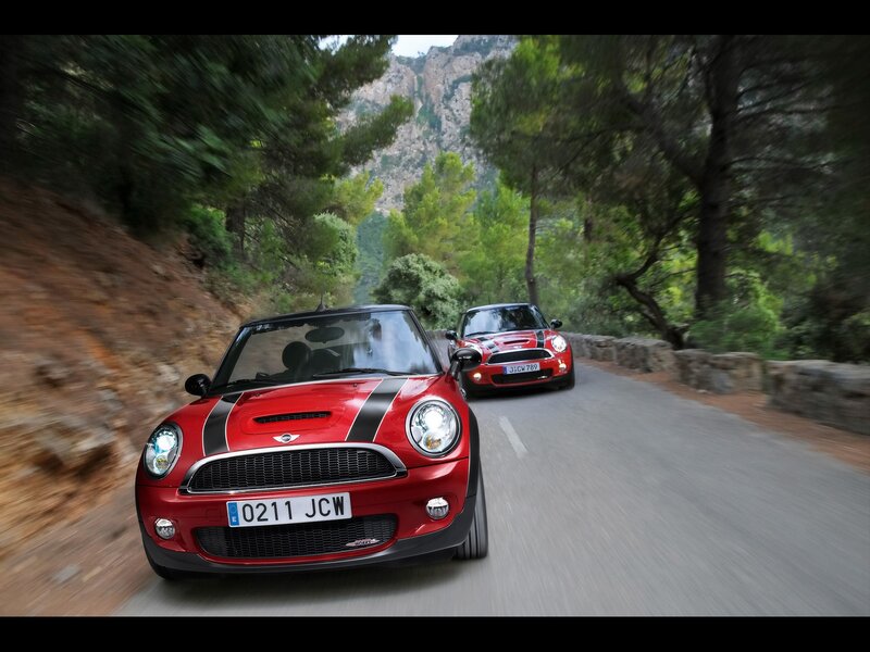 Red MINI cars on a forest road