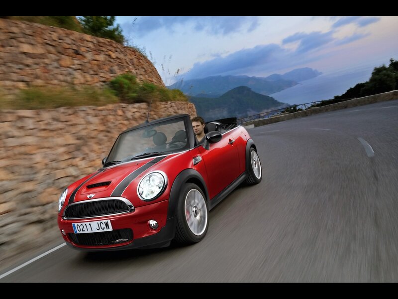 Red MINI convertible on coastal road