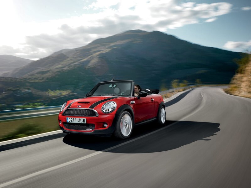 Red MINI convertible on mountain road