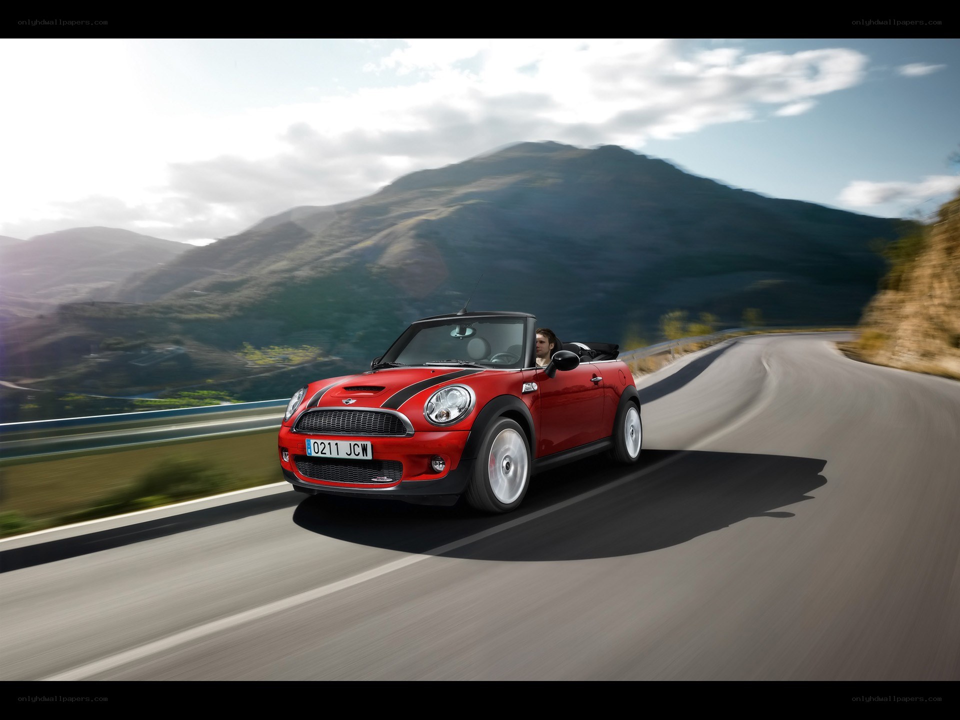 Red MINI convertible on mountain road