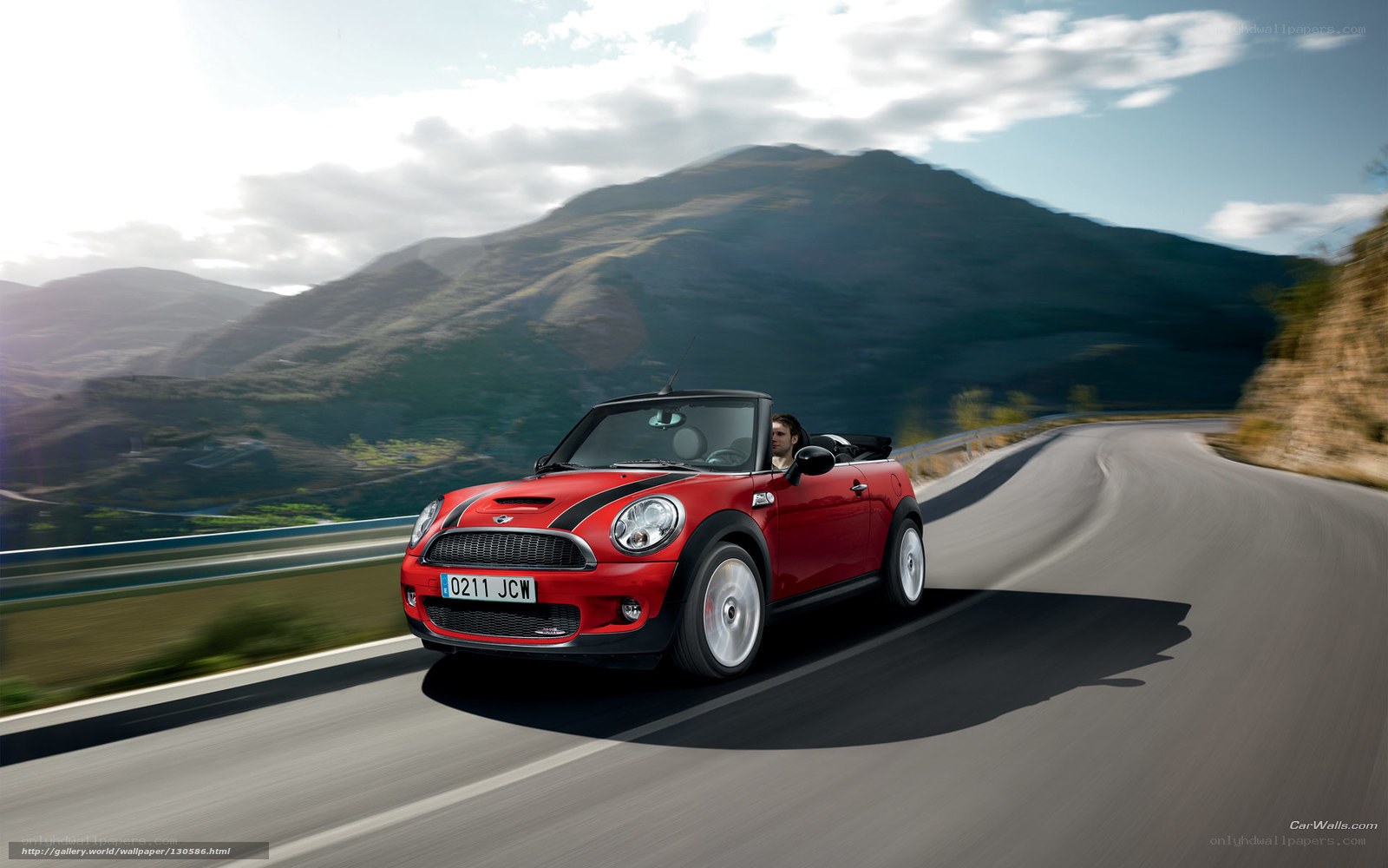 Red MINI convertible on mountain road