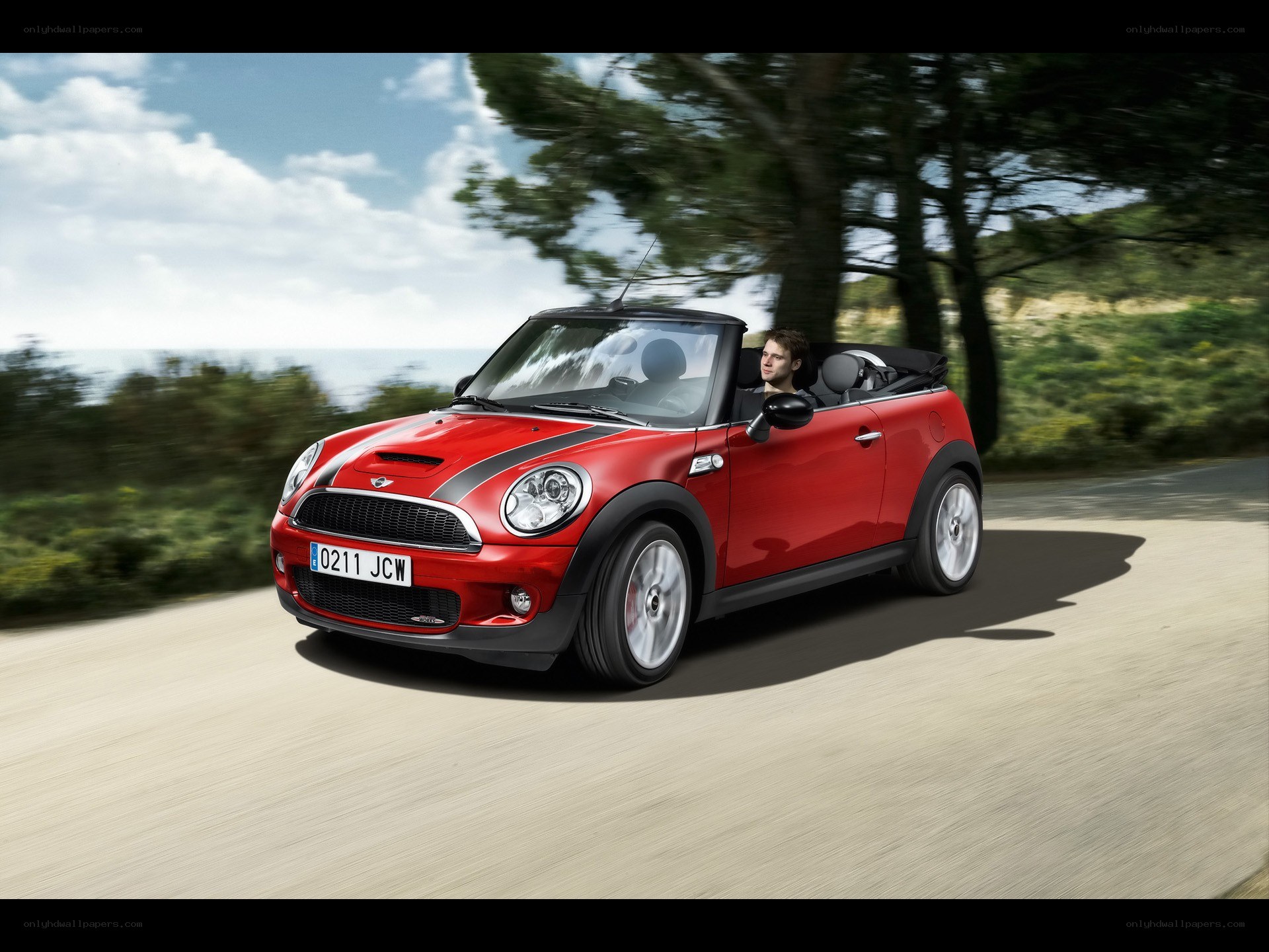 Red MINI Cooper convertible driving
