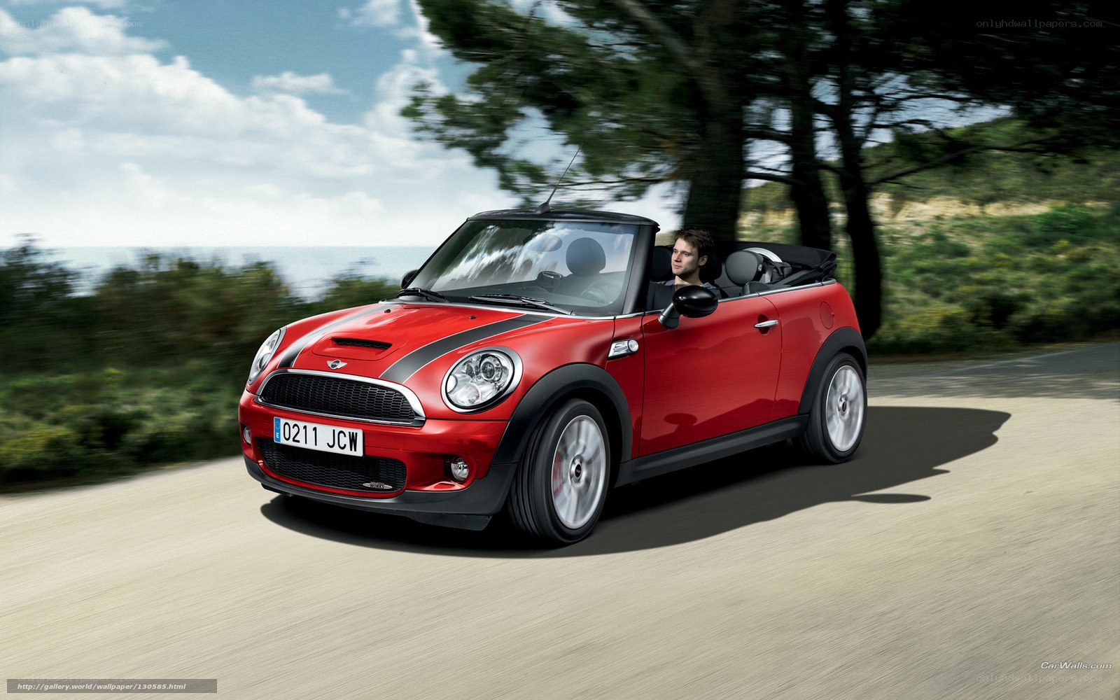 Red MINI Cooper driving on coastal road