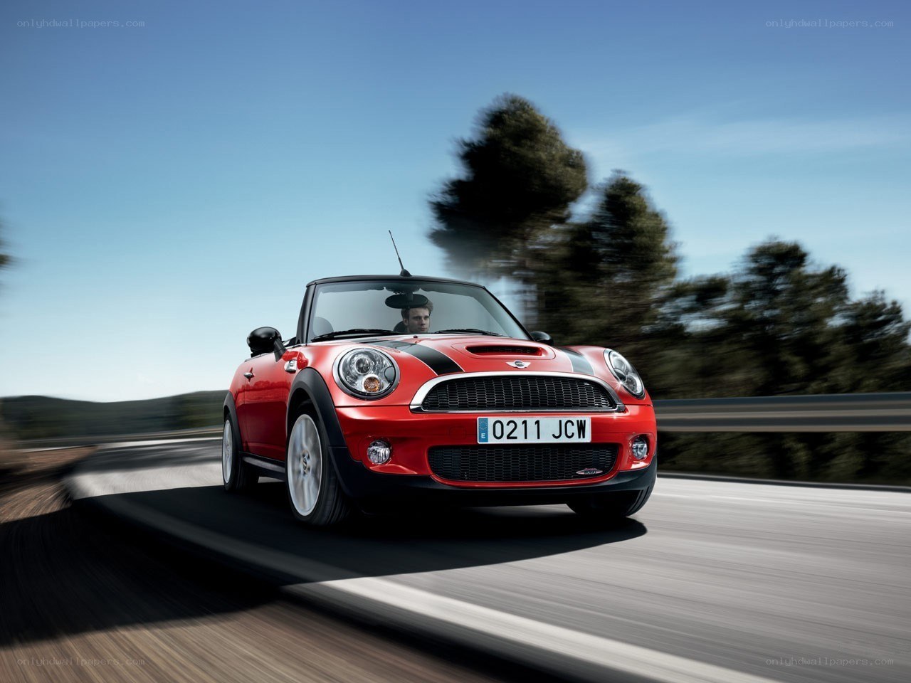Red MINI Cooper driving on road