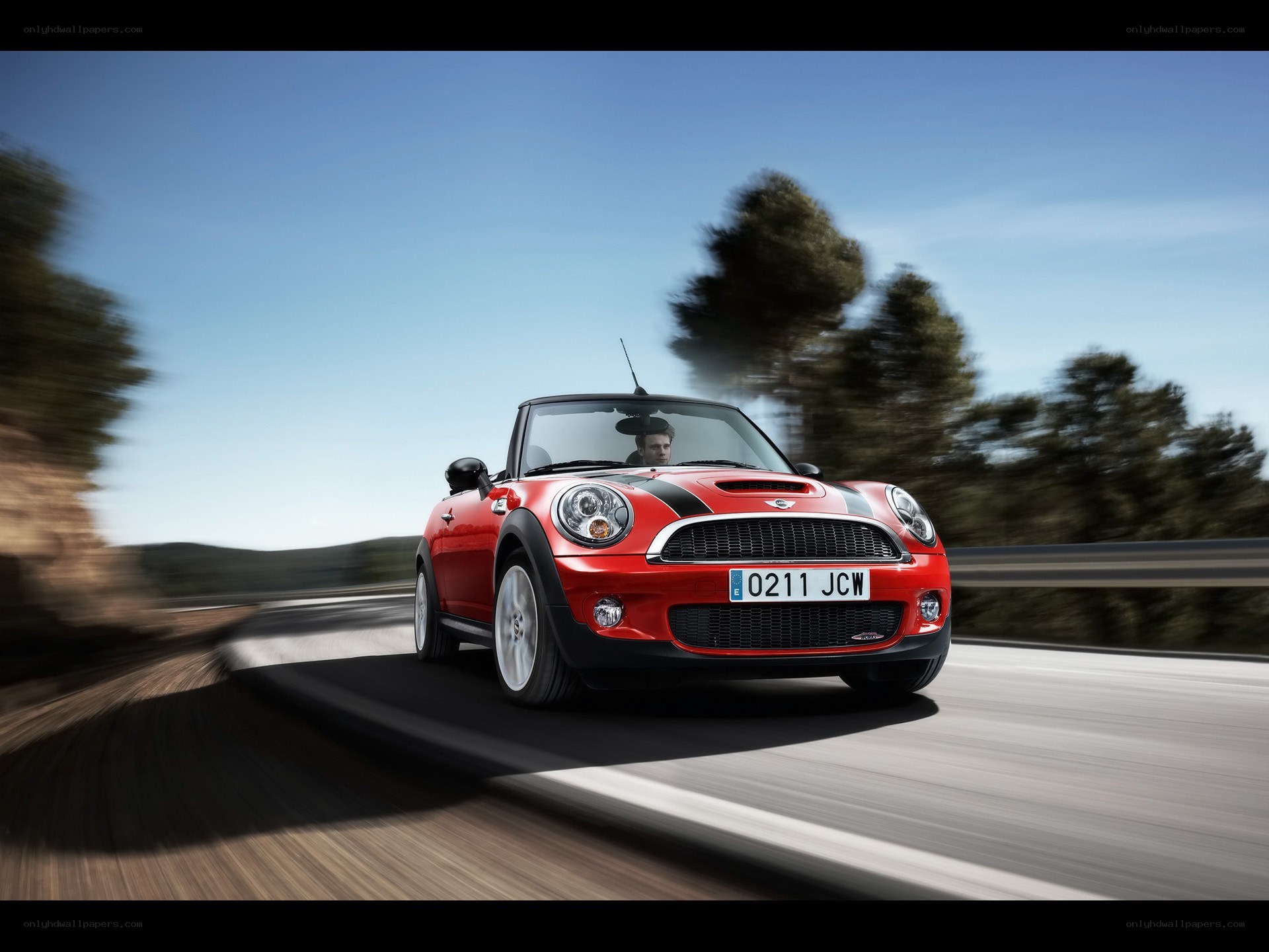 Red MINI Cooper driving on road