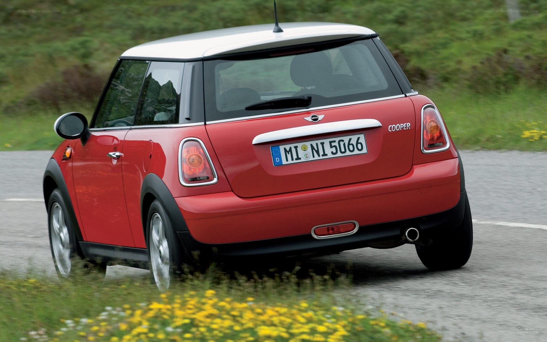 Red Mini Cooper driving on road