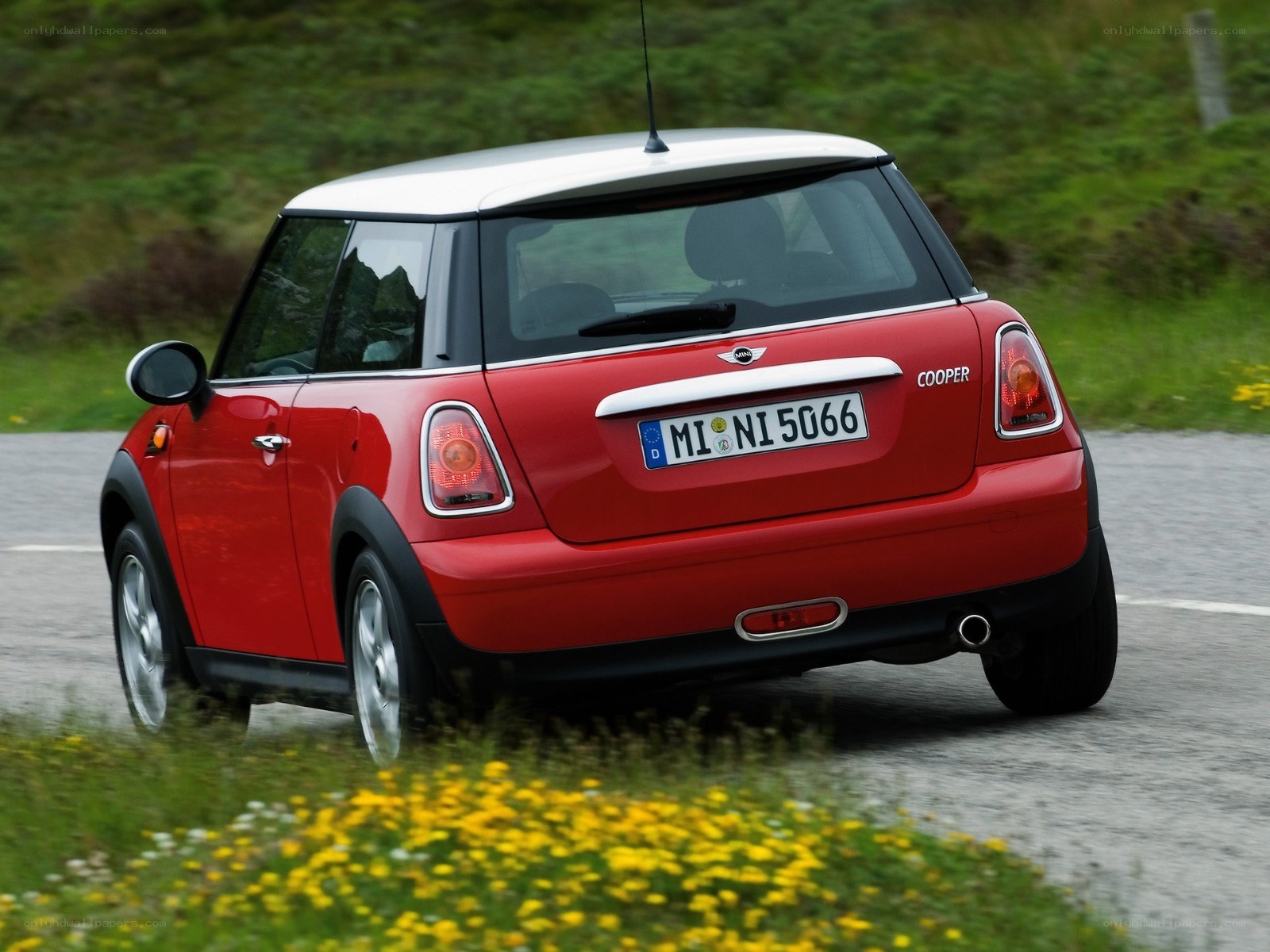 red mini cooper driving on road