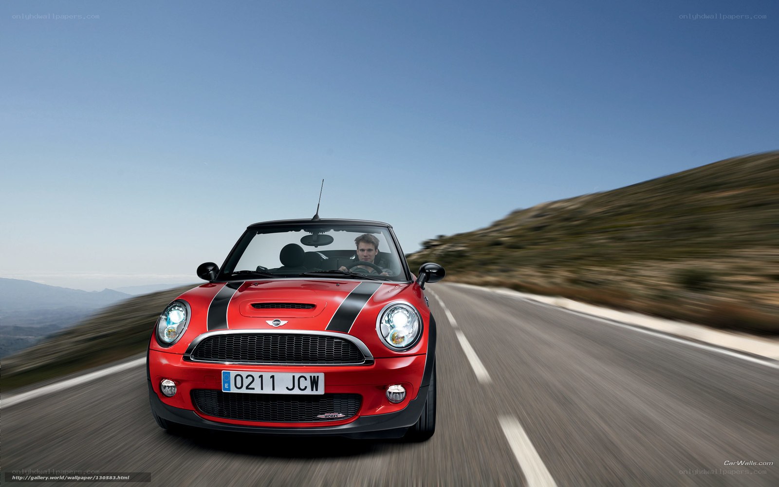 Red MINI Cooper driving on road