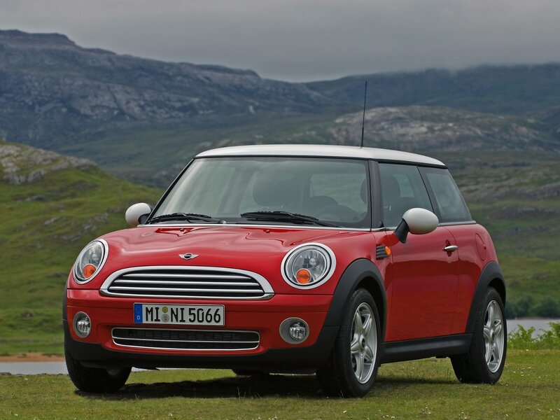 Red Mini Cooper in a scenic landscape