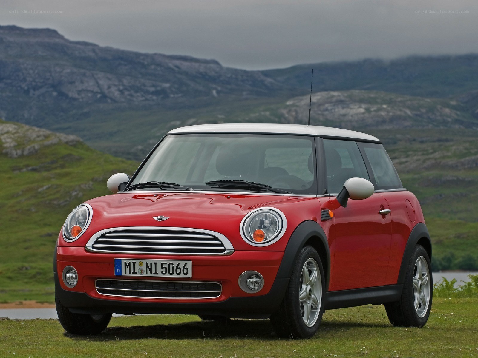 Red Mini Cooper in a scenic landscape