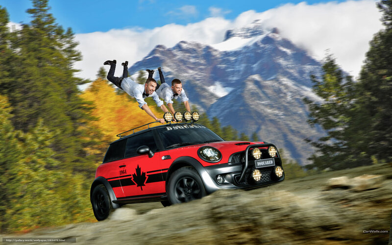 Red Mini Cooper with men on roof