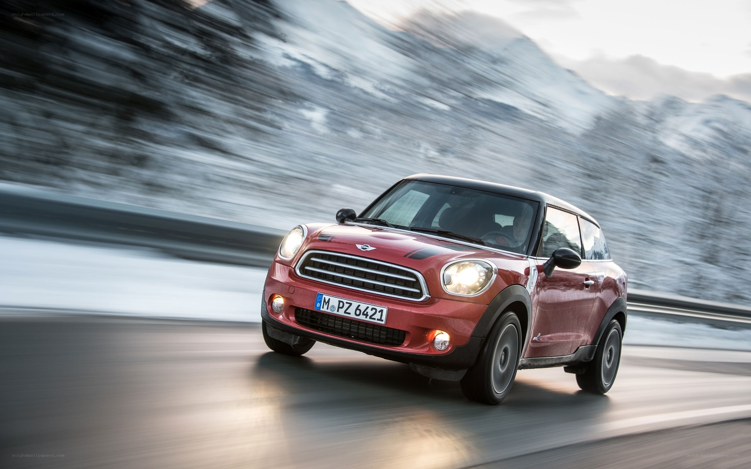 Red Mini Countryman driving on mountain road