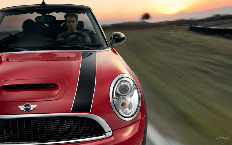 Red MINI driving at sunset