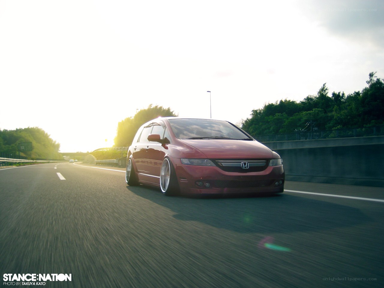 Red minivan on highway