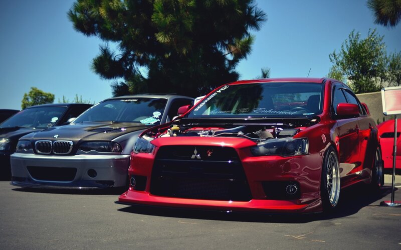 Red Mitsubishi and BMW at car show