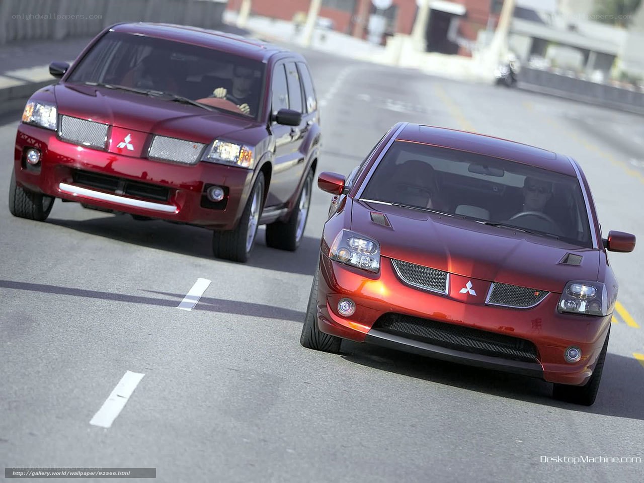 Red Mitsubishi cars on road