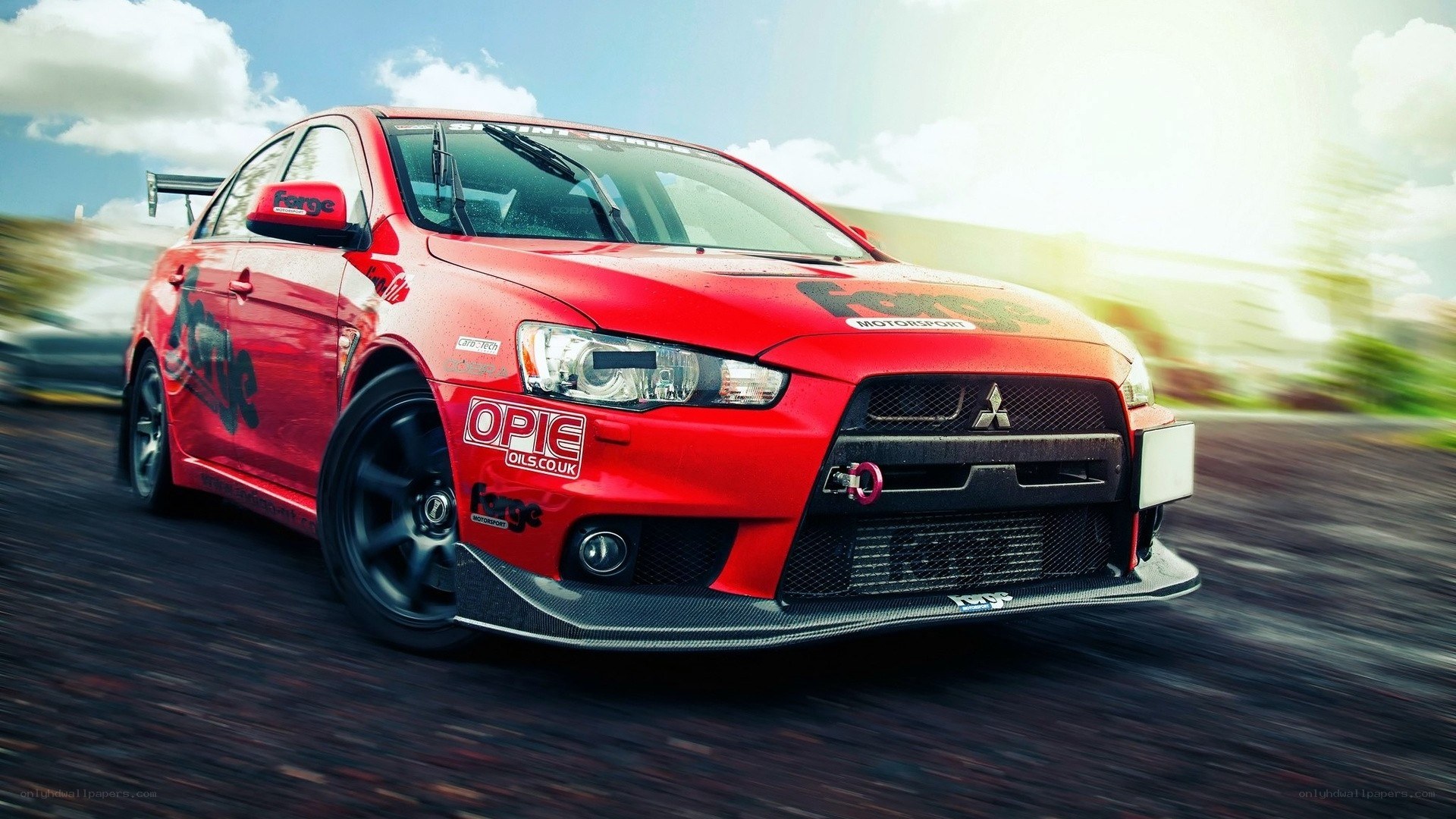 red mitsubishi lancer evo on track