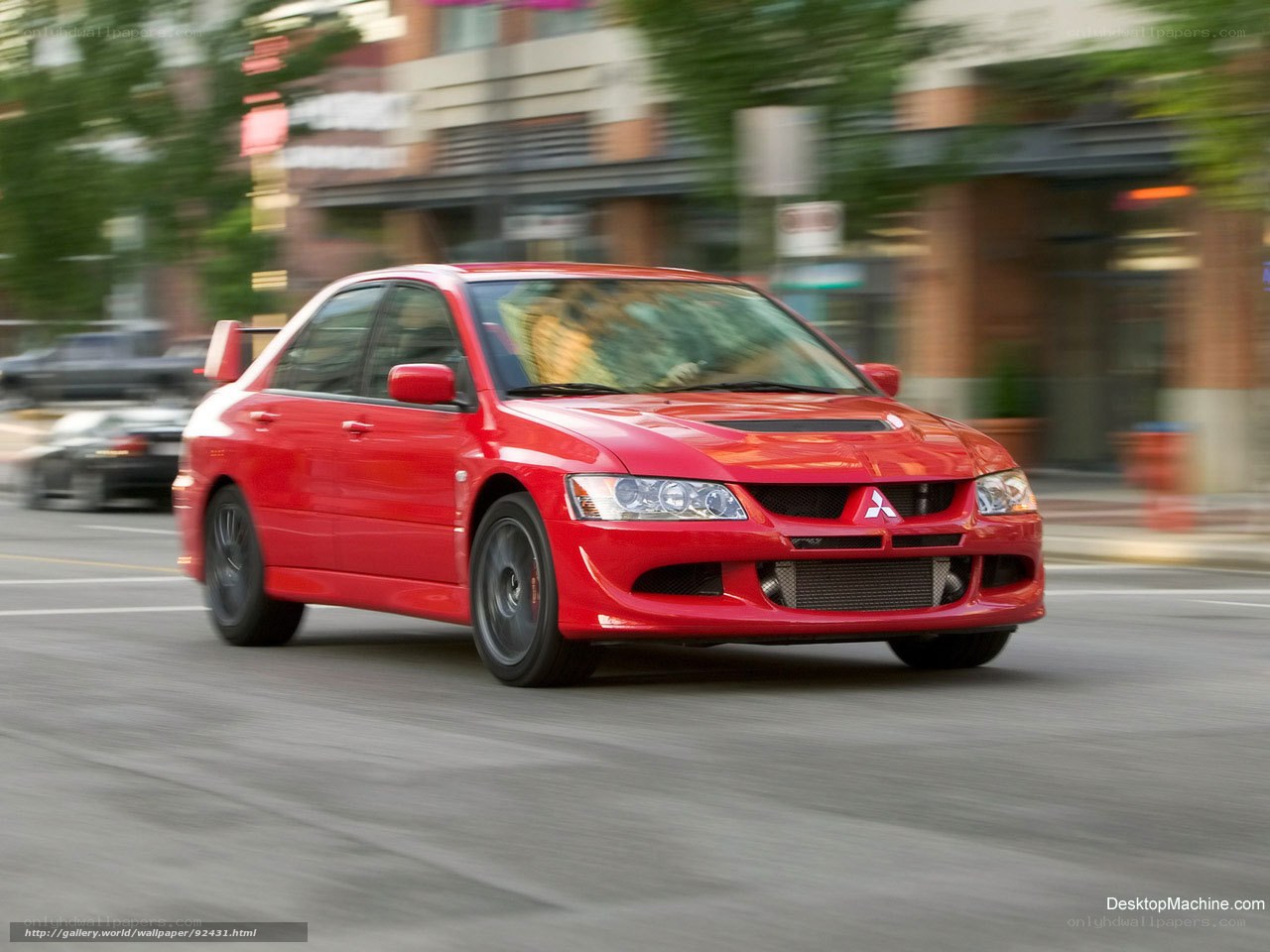 Red Mitsubishi Lancer Evolution in motion