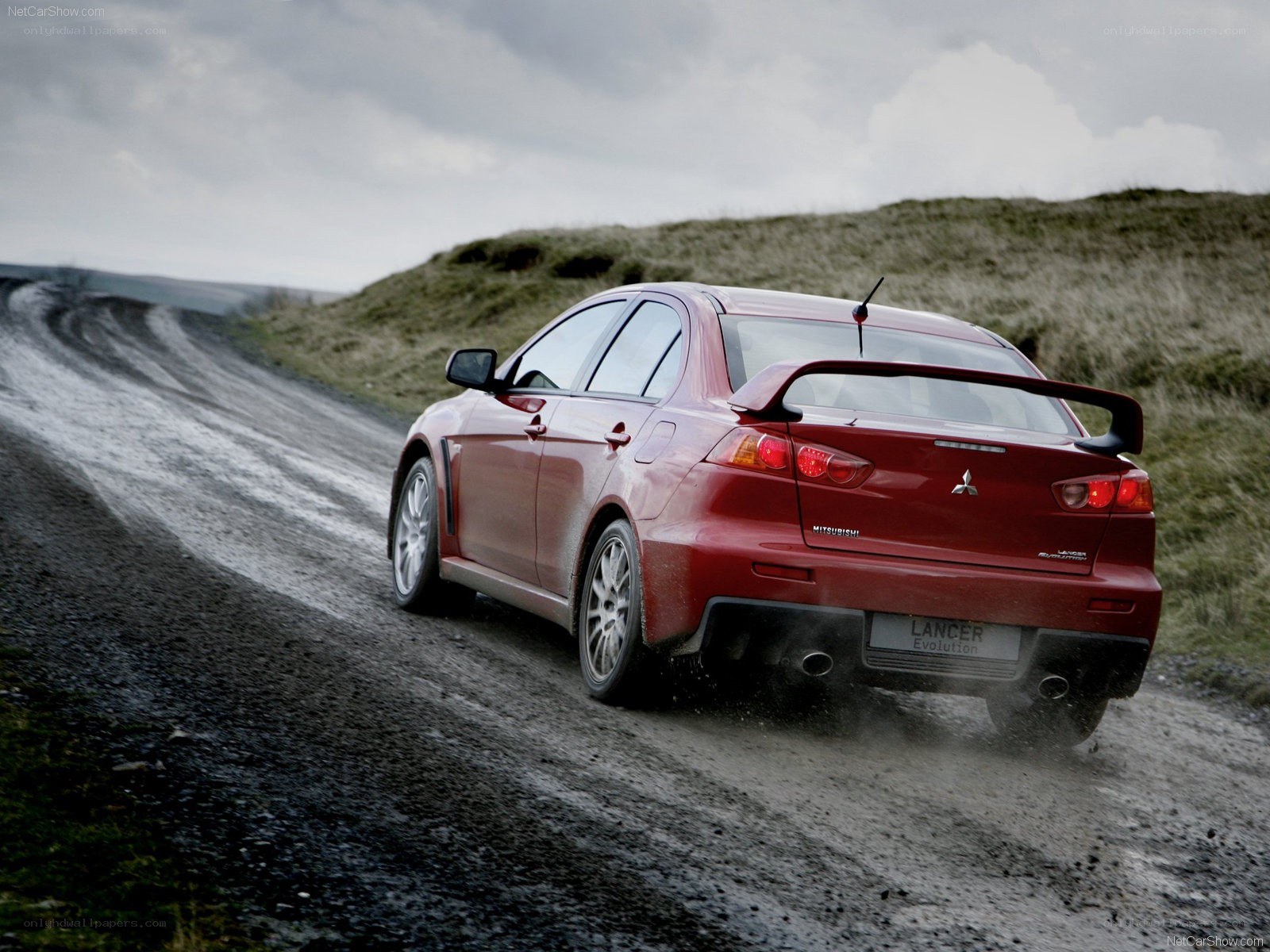 Red Mitsubishi Lancer Evolution on dirt road