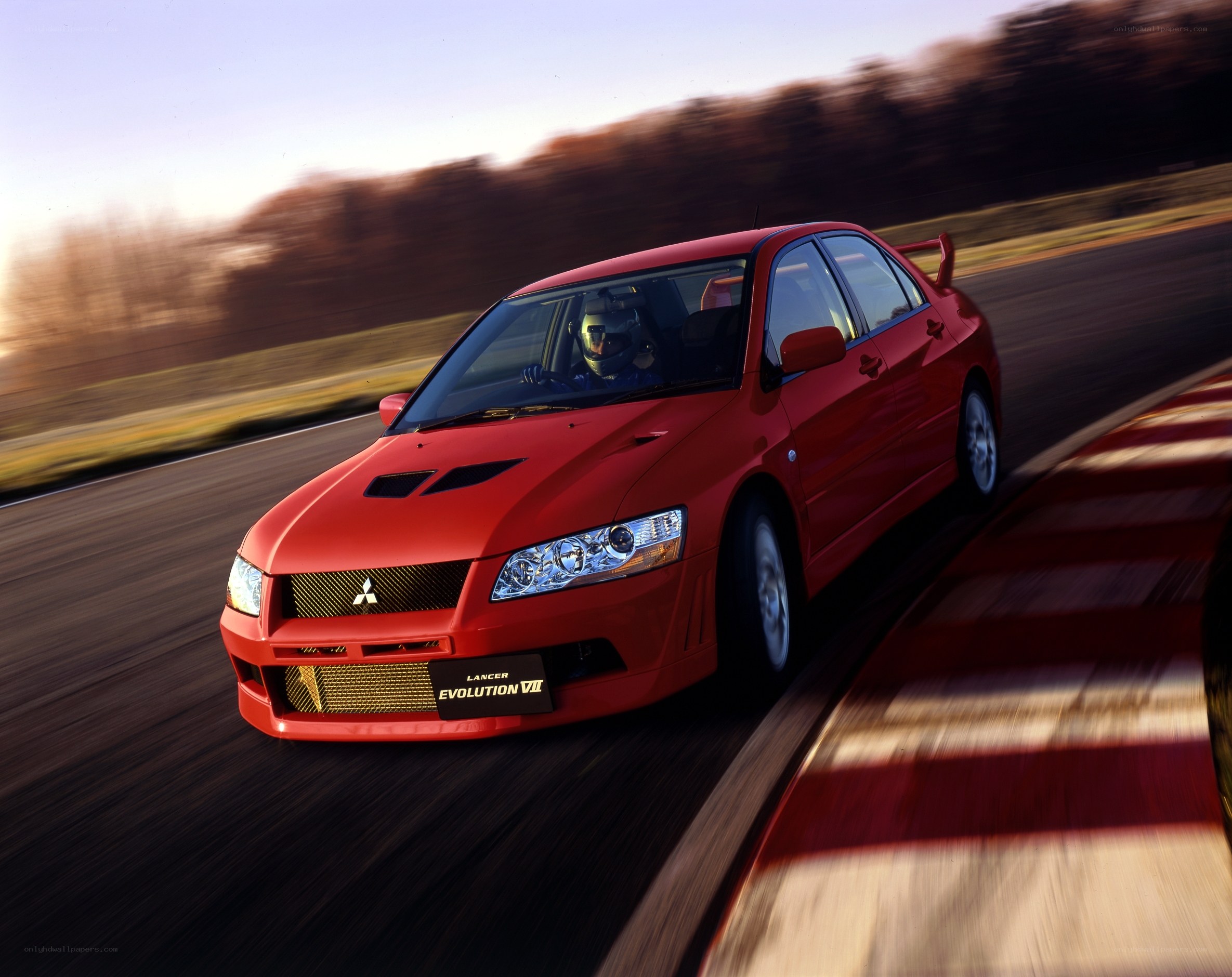 Red Mitsubishi Lancer Evolution on track