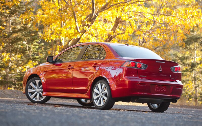 Red Mitsubishi Lancer in autumn
