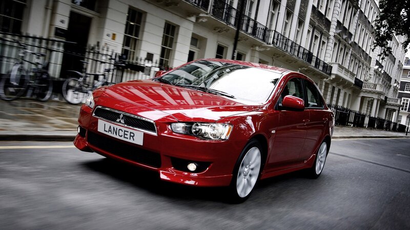 Red Mitsubishi Lancer in city