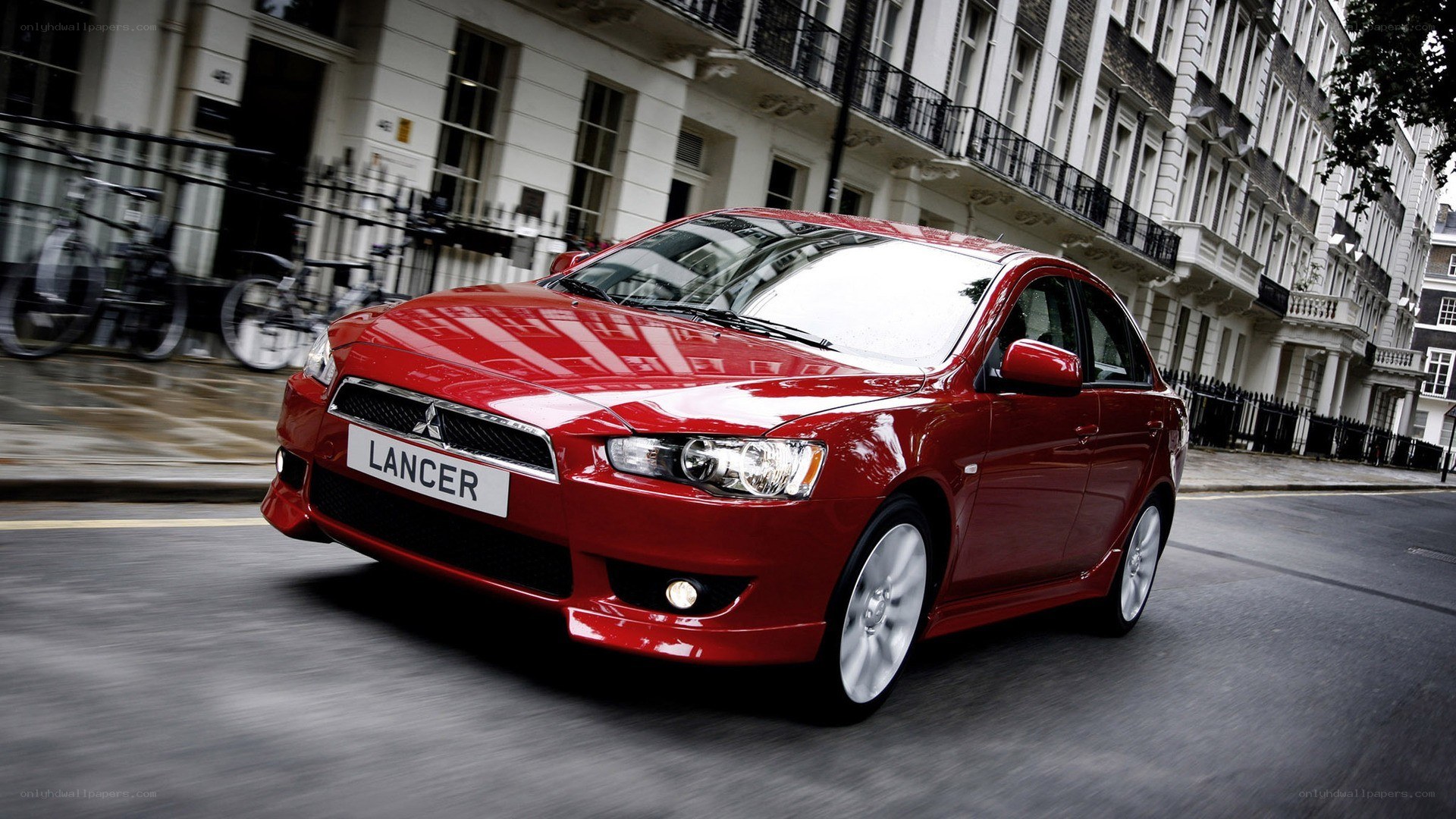 Red Mitsubishi Lancer in city