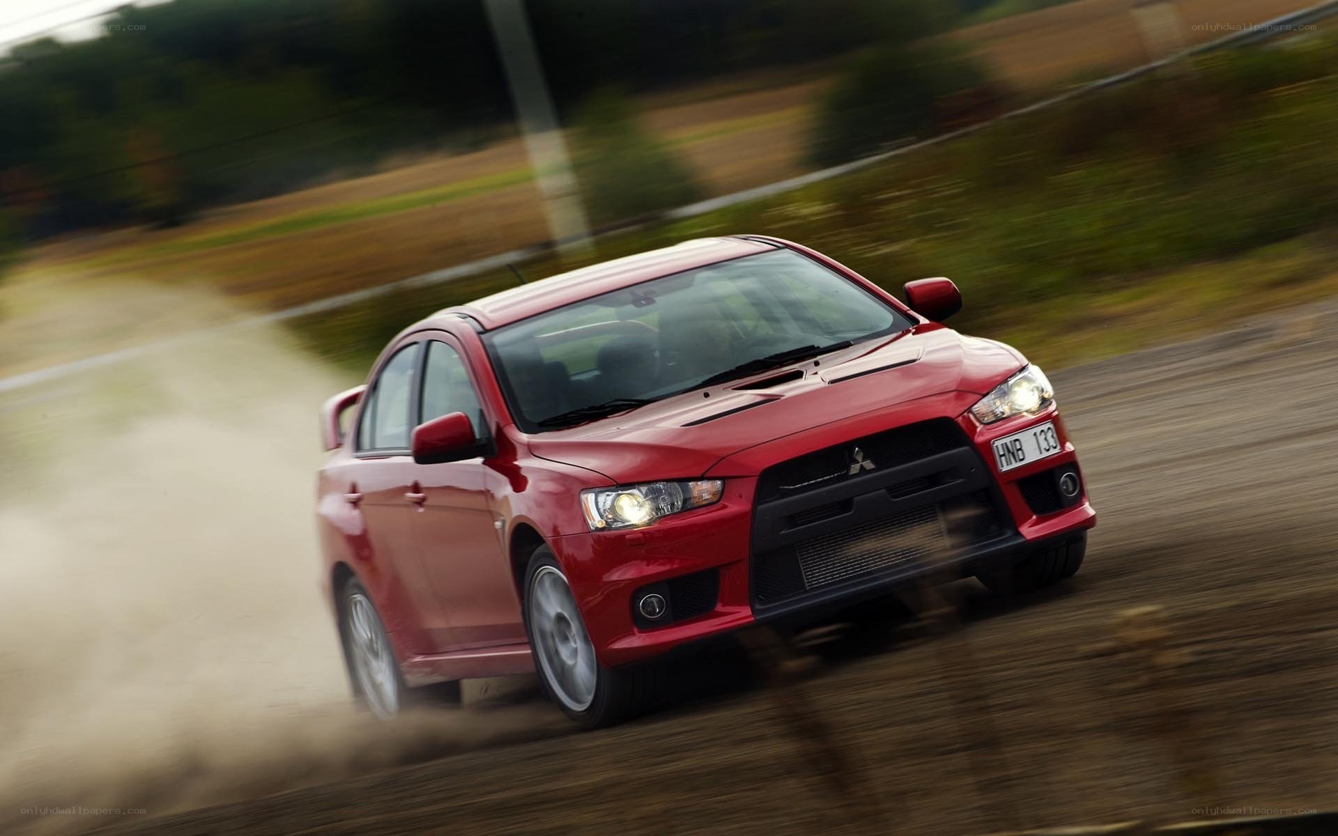 red mitsubishi lancer in motion