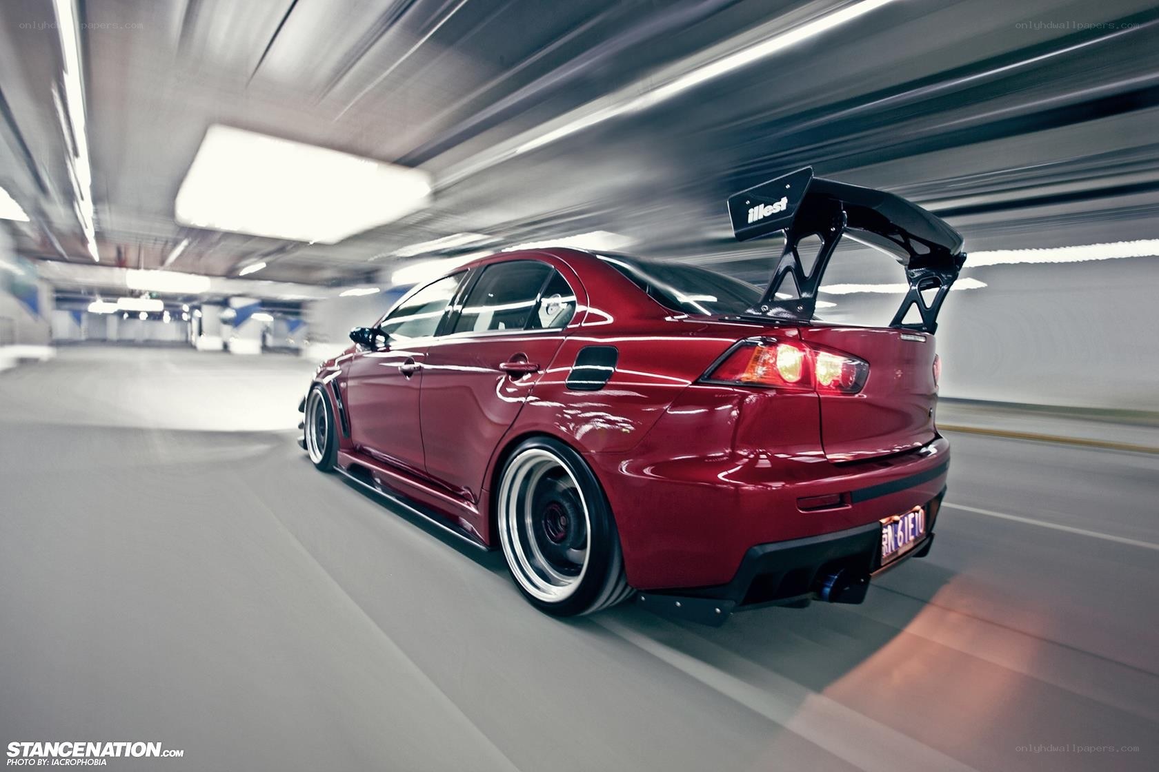 Red Mitsubishi Lancer in motion