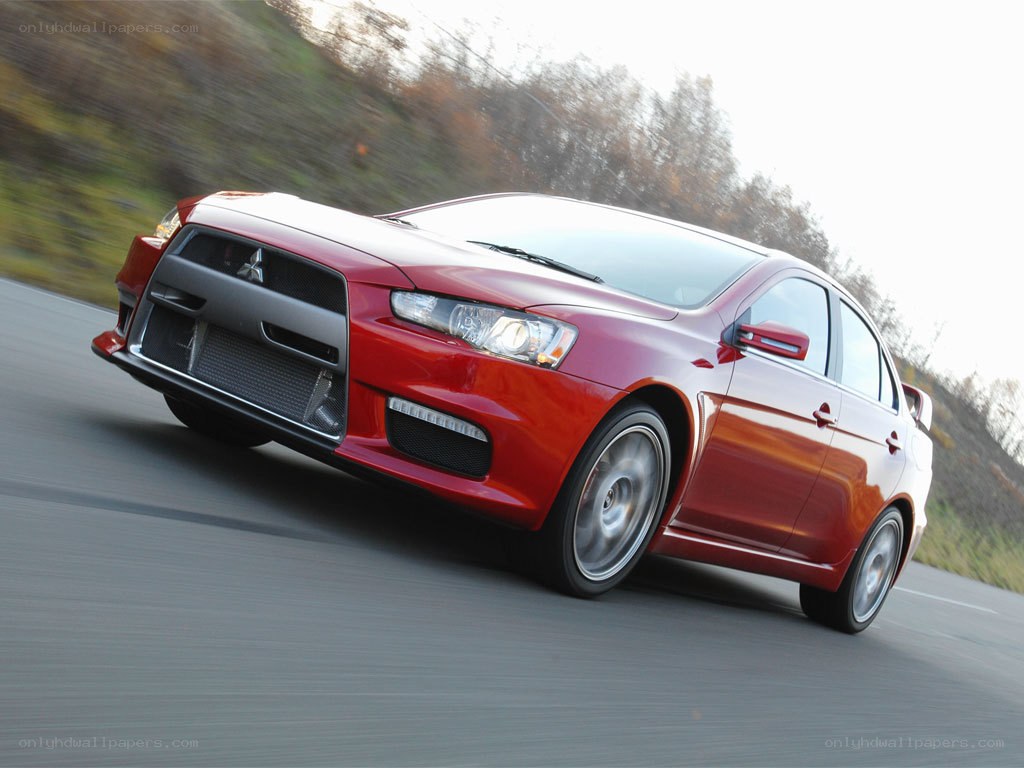 red mitsubishi lancer in motion