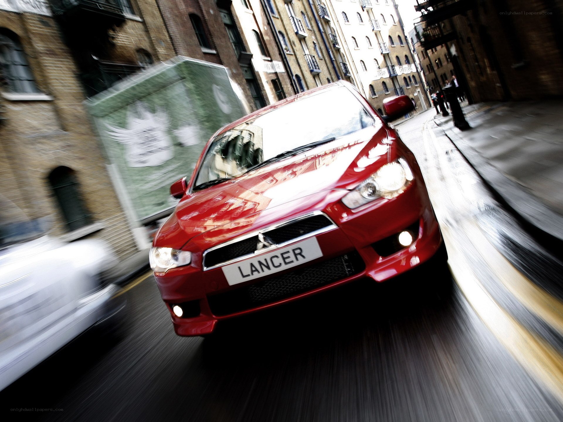 Red Mitsubishi Lancer in motion
