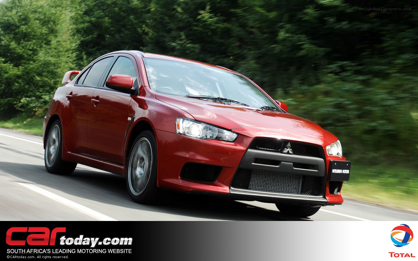 red mitsubishi lancer in motion