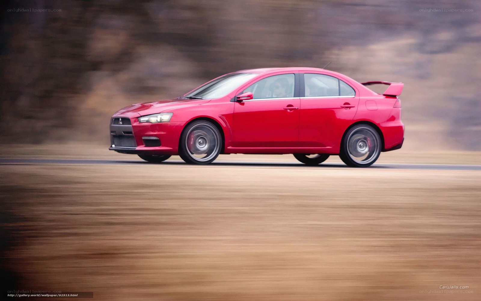 red mitsubishi lancer in motion