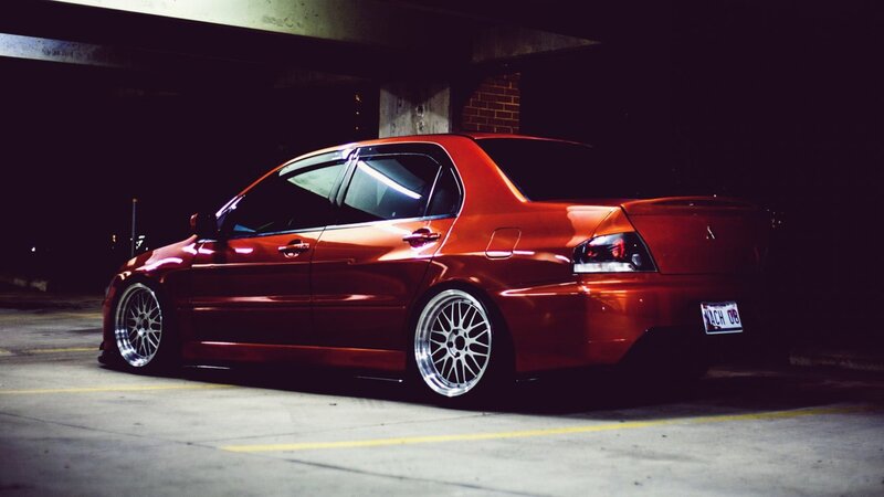 red mitsubishi lancer in parking garage