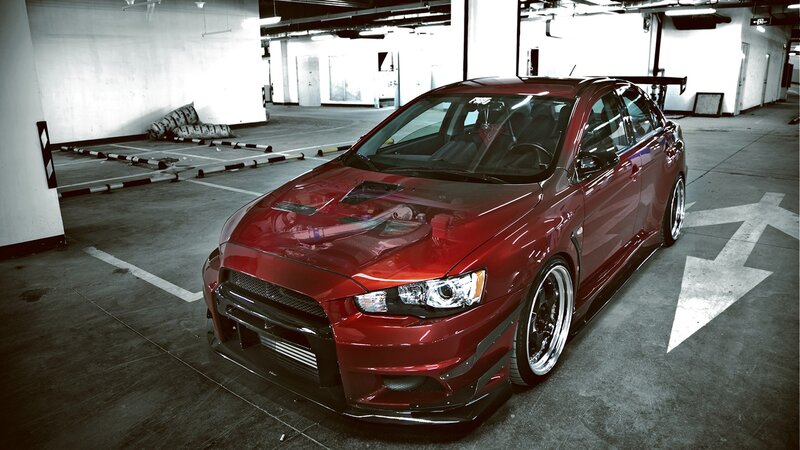Red Mitsubishi Lancer in parking garage