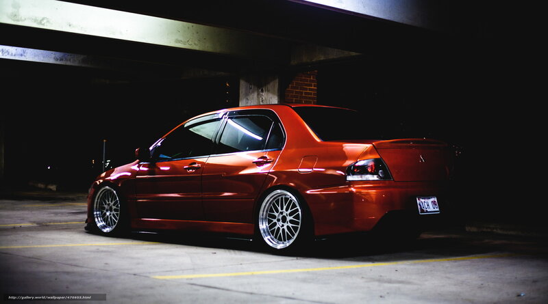 Red Mitsubishi Lancer in parking garage