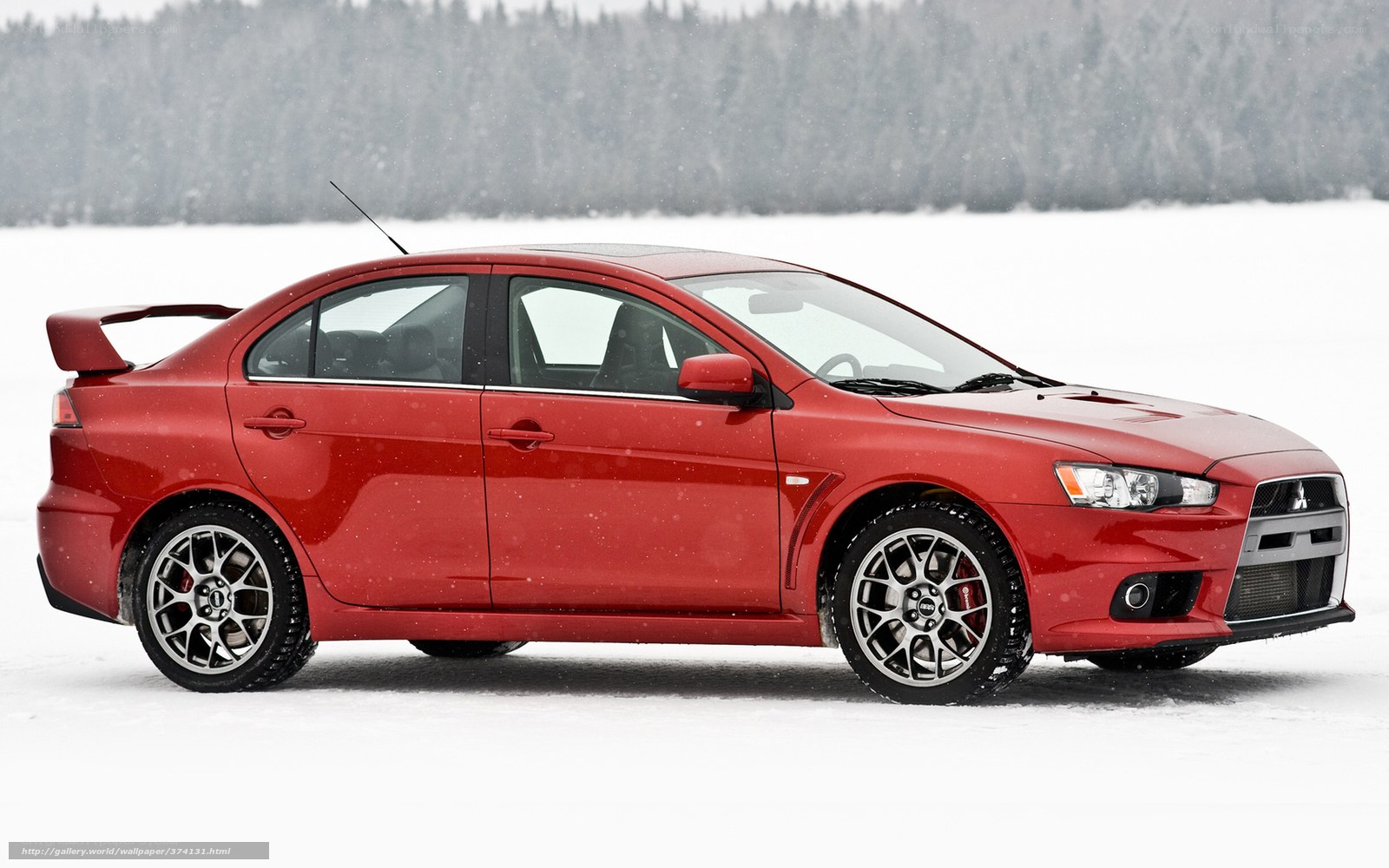 Red Mitsubishi Lancer in snow