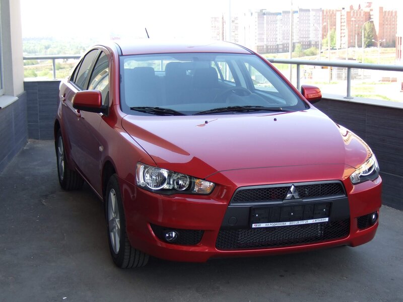 Red Mitsubishi Lancer sedan