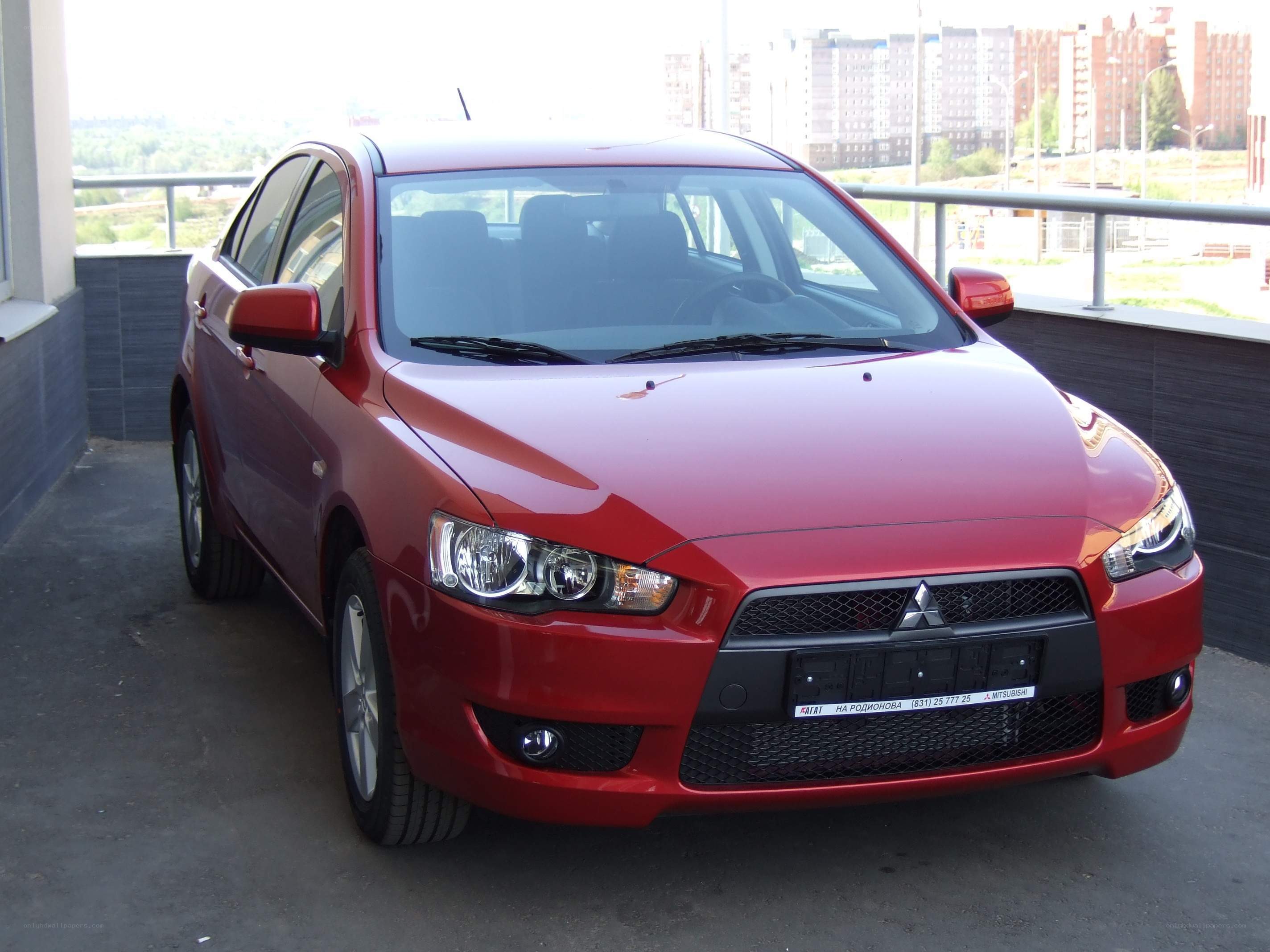 Red Mitsubishi Lancer sedan