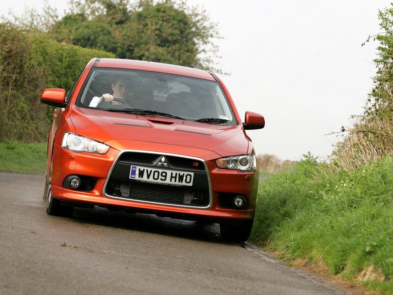 red mitsubishi on country road