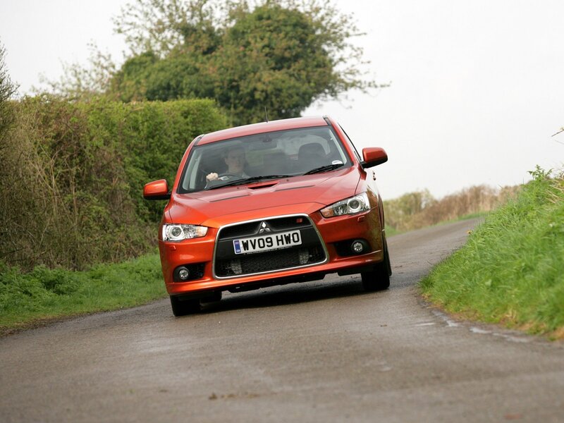 red mitsubishi on country road